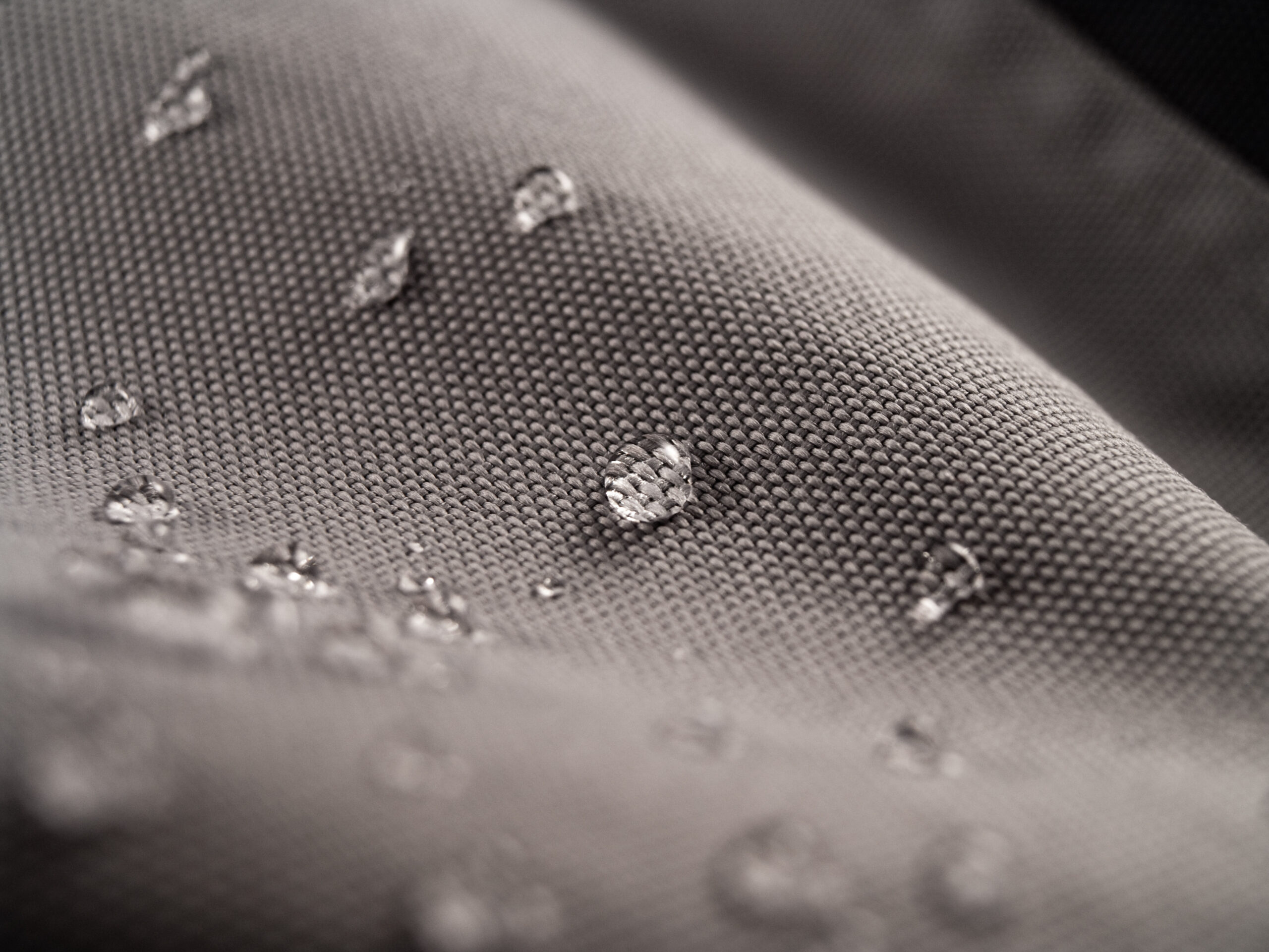 waterproof textile clothing Macro shot of water rain drops on waterproof textile jacket. Extreme depth of field. Please visit my portfolio for different shots of this subject.