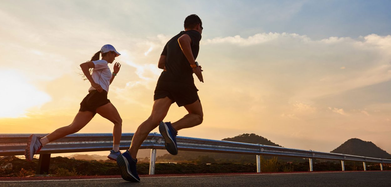 Woman-and-Man-running-on-a-street-with-a-sunset